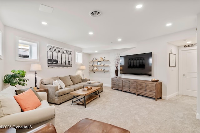 living room featuring light carpet, baseboards, visible vents, and recessed lighting