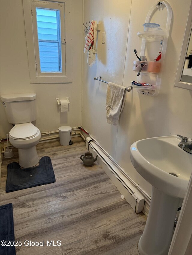 16 Parkview Ct, Troy, NY 12180 - bathroom featuring a sink, toilet, wood finished floors, and a baseboard radiator