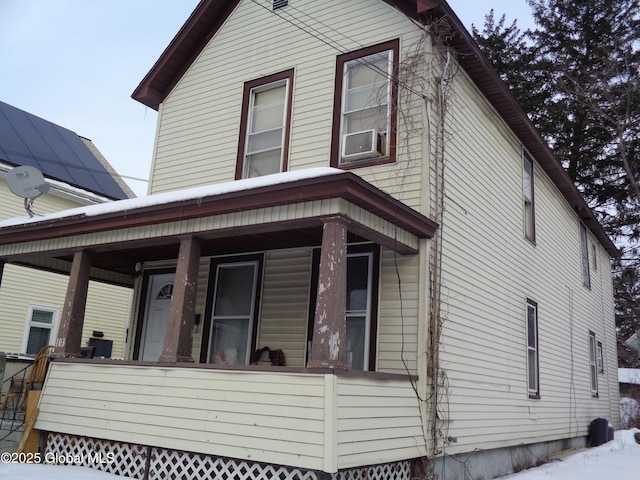 view of front of property with a porch and cooling unit