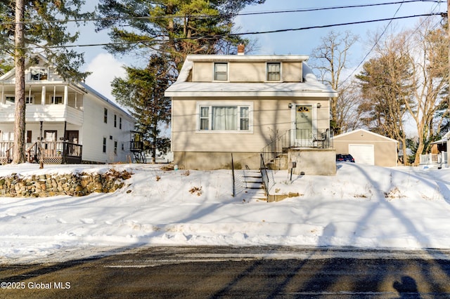 view of front of home with a garage and an outdoor structure