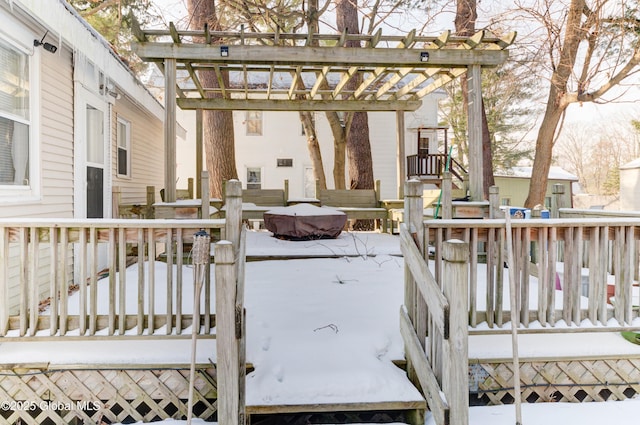 snow covered deck featuring a pergola