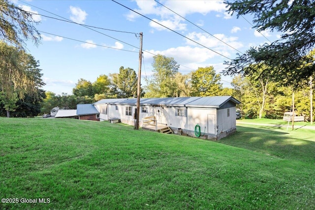 rear view of property featuring a yard