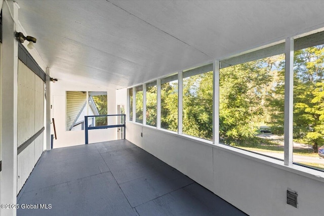 unfurnished sunroom with vaulted ceiling