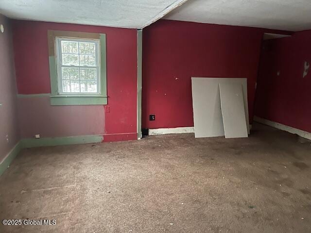 unfurnished room with a textured ceiling