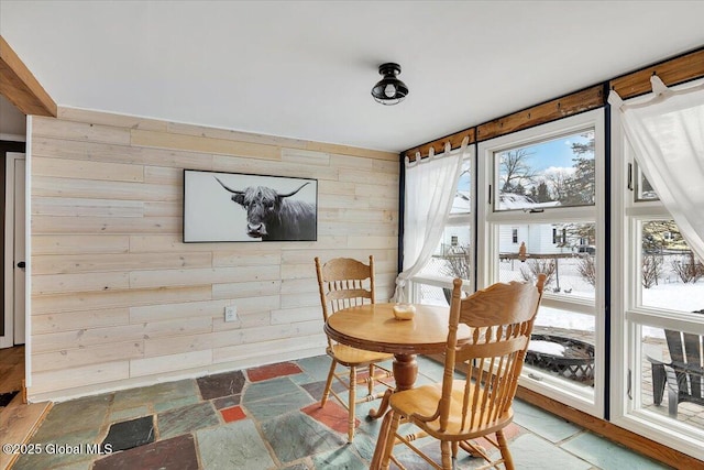 dining room with wood walls