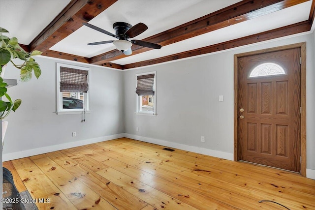 entryway with ceiling fan, wood-type flooring, and beamed ceiling