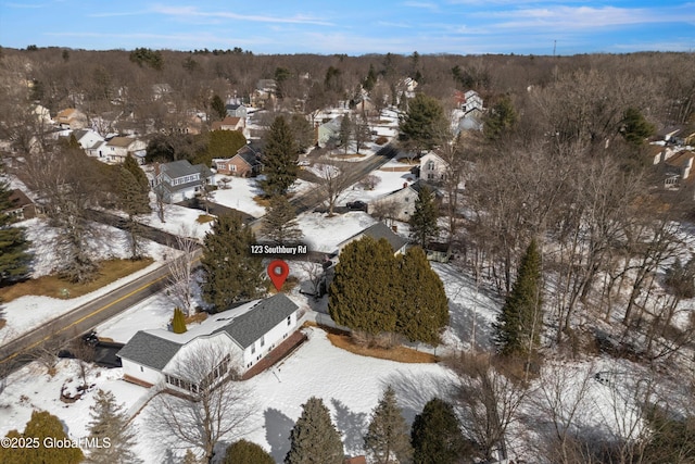 snowy aerial view with a residential view