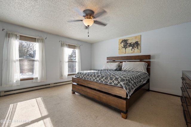 carpeted bedroom featuring a ceiling fan, a baseboard heating unit, and a textured ceiling