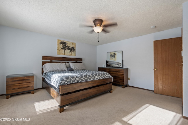 carpeted bedroom with baseboards, a ceiling fan, and a textured ceiling