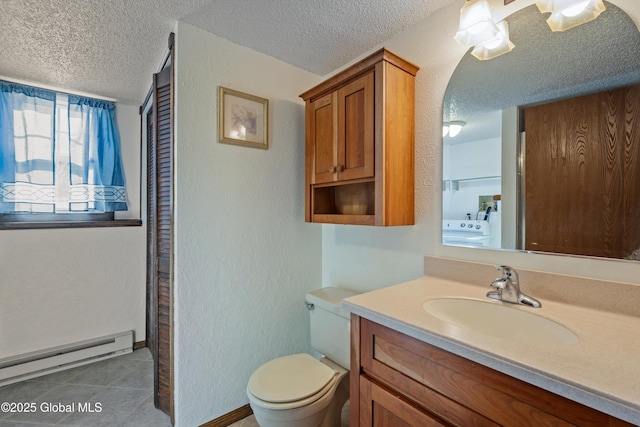 bathroom featuring a baseboard radiator, washer / clothes dryer, toilet, a textured ceiling, and tile patterned flooring