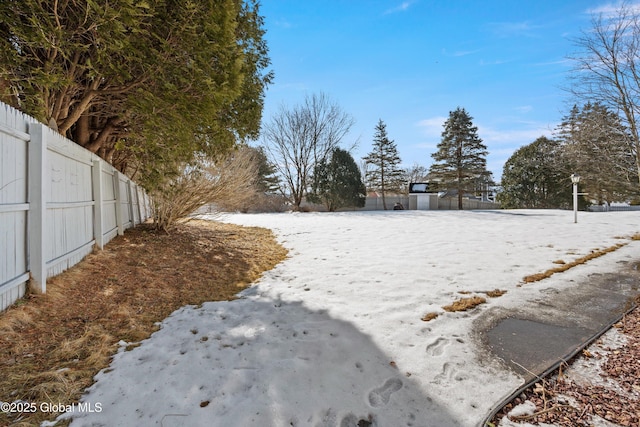 yard covered in snow with fence