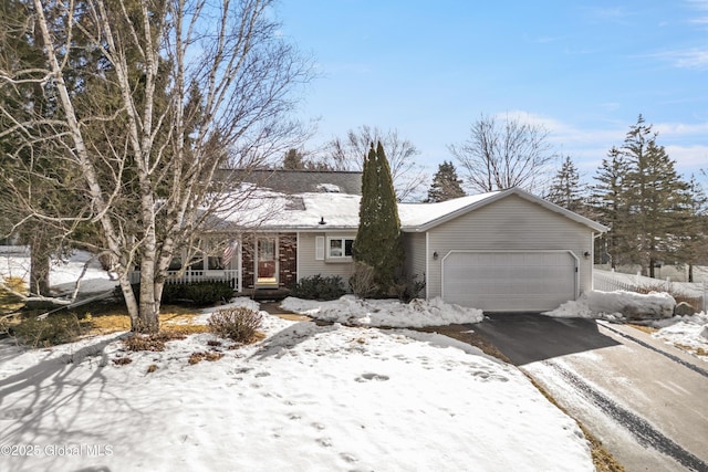 view of front of home with an attached garage and aphalt driveway