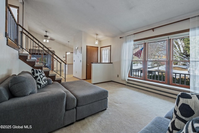 carpeted living area with a baseboard heating unit, stairway, a textured ceiling, and baseboards