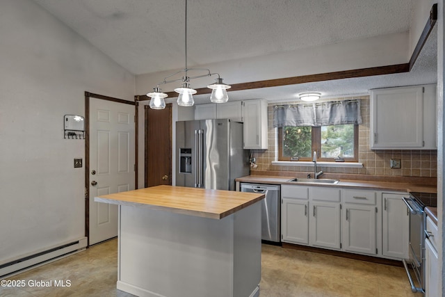 kitchen with a baseboard radiator, wooden counters, appliances with stainless steel finishes, white cabinetry, and a sink