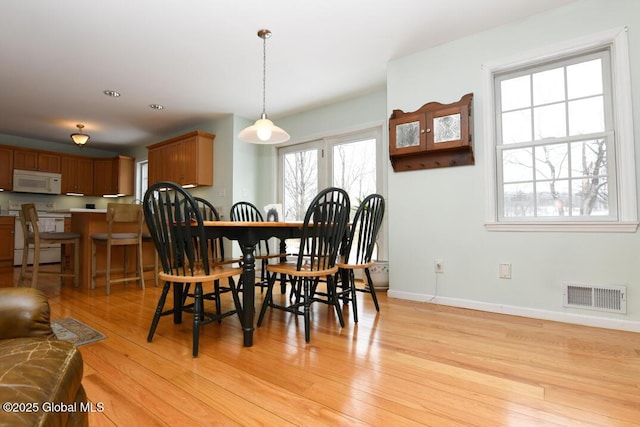 dining area with light wood-type flooring