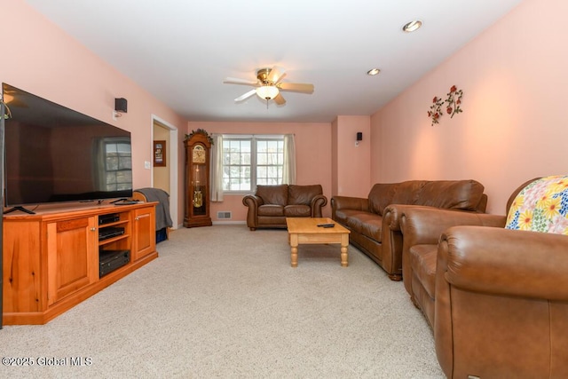 living room with light carpet and ceiling fan