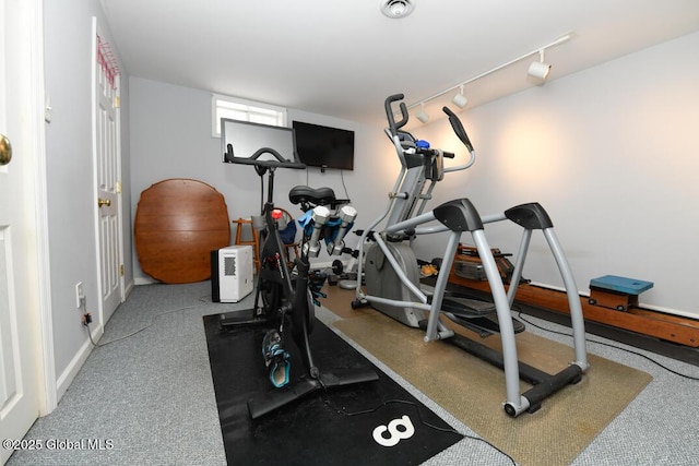 workout area featuring track lighting