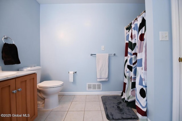 bathroom featuring vanity, tile patterned floors, and toilet