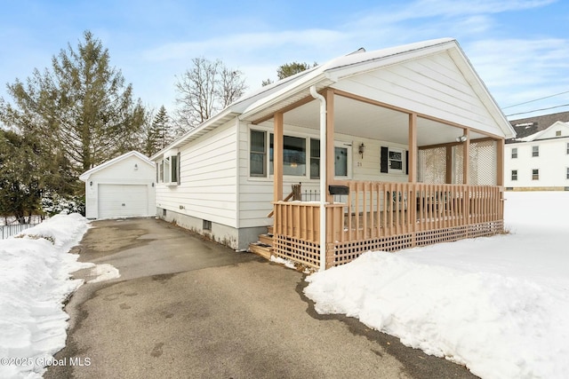 view of front of house with a garage, an outdoor structure, and covered porch