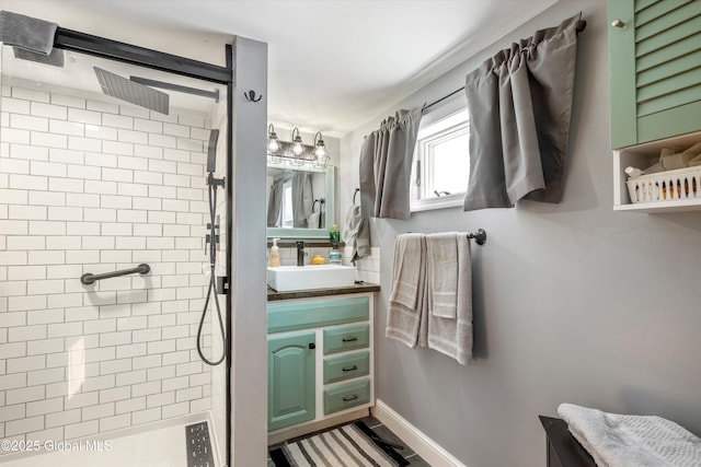 bathroom with a stall shower, vanity, and baseboards