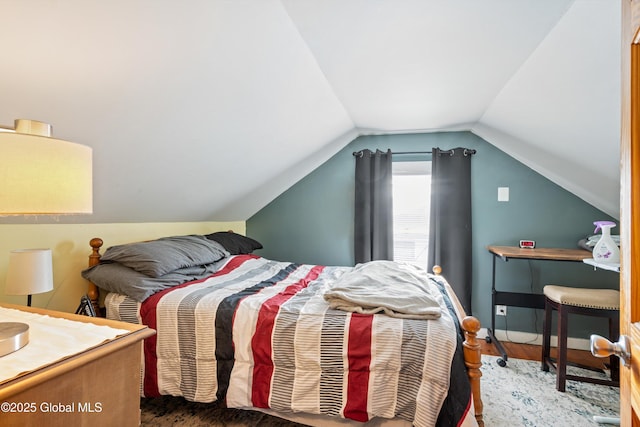 bedroom with lofted ceiling and dark wood finished floors