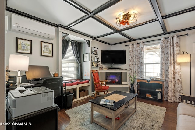 living room with coffered ceiling, a glass covered fireplace, a wall unit AC, and dark wood-style floors