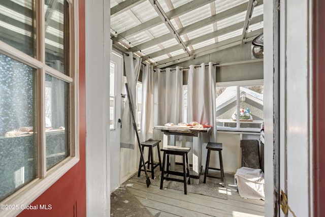 sunroom / solarium featuring vaulted ceiling