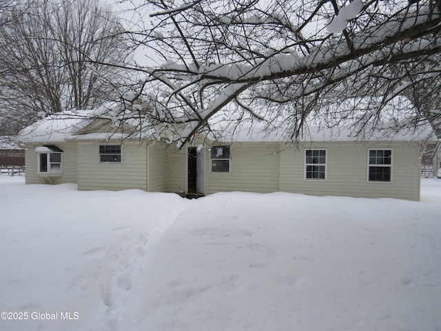 view of snow covered rear of property