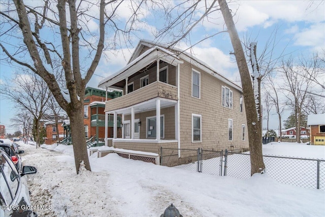 view of snow covered exterior featuring a balcony