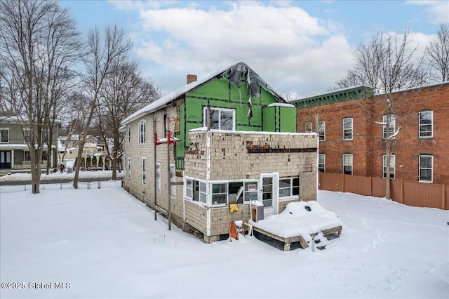 view of snow covered rear of property