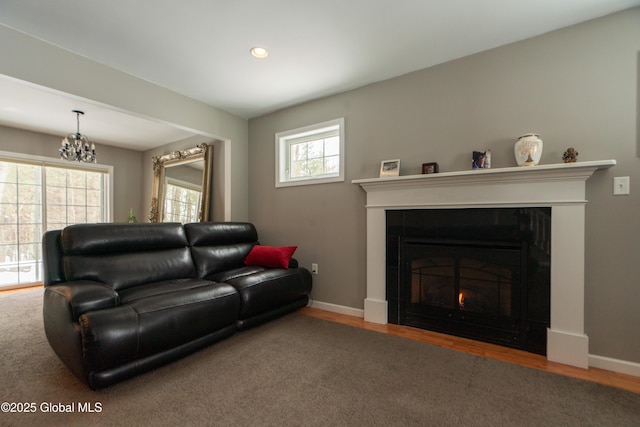 living room with a healthy amount of sunlight, a chandelier, and hardwood / wood-style floors