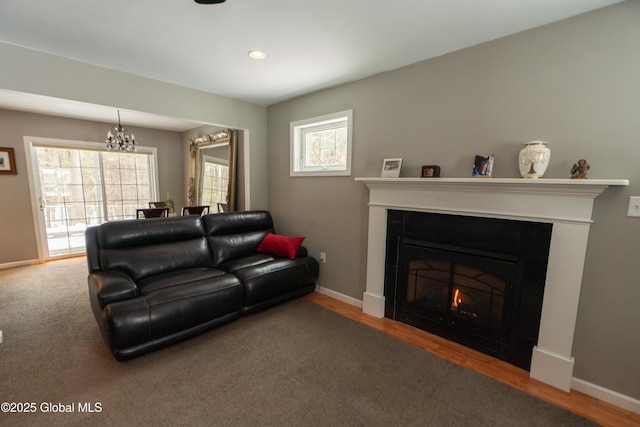 living room featuring wood-type flooring and an inviting chandelier