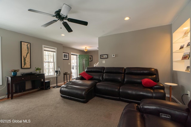 carpeted living room with ceiling fan