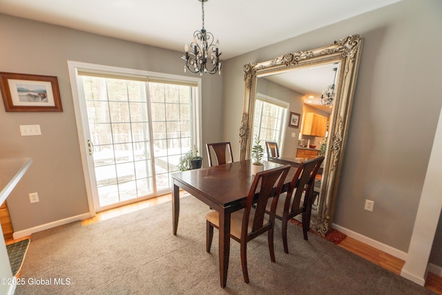 dining room with hardwood / wood-style floors and a notable chandelier