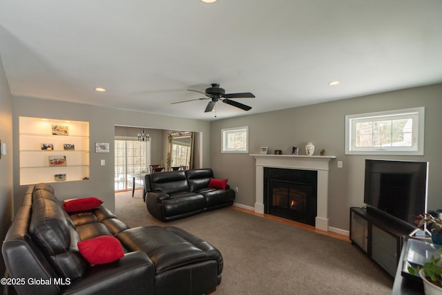 living room featuring carpet floors, plenty of natural light, and ceiling fan