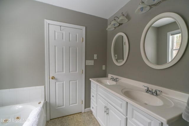 bathroom with vanity and a washtub