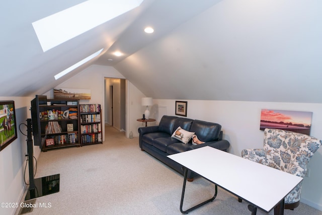 carpeted office featuring vaulted ceiling with skylight