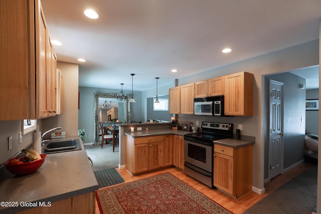 kitchen with electric stove, sink, light hardwood / wood-style floors, decorative light fixtures, and kitchen peninsula