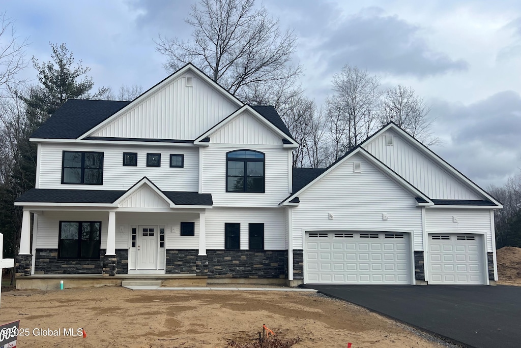 view of front of property with a porch and a garage