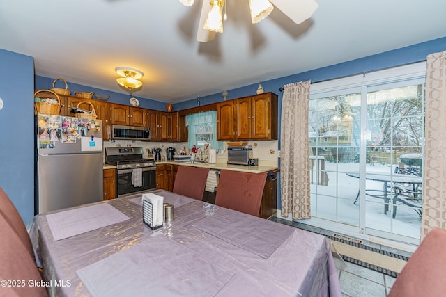 kitchen with sink, plenty of natural light, ceiling fan, and appliances with stainless steel finishes