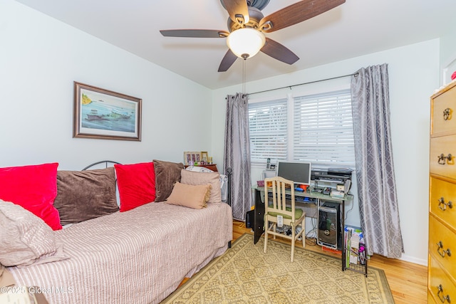 bedroom with ceiling fan and wood-type flooring