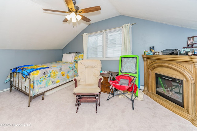 carpeted bedroom featuring ceiling fan and vaulted ceiling