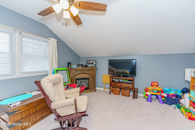 interior space with lofted ceiling, ceiling fan, and carpet flooring