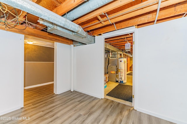 basement with gas water heater and light wood-type flooring