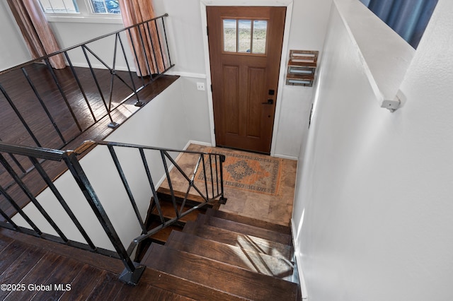 stairs with baseboards and hardwood / wood-style flooring