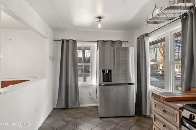 kitchen with tile patterned flooring, a healthy amount of sunlight, and appliances with stainless steel finishes