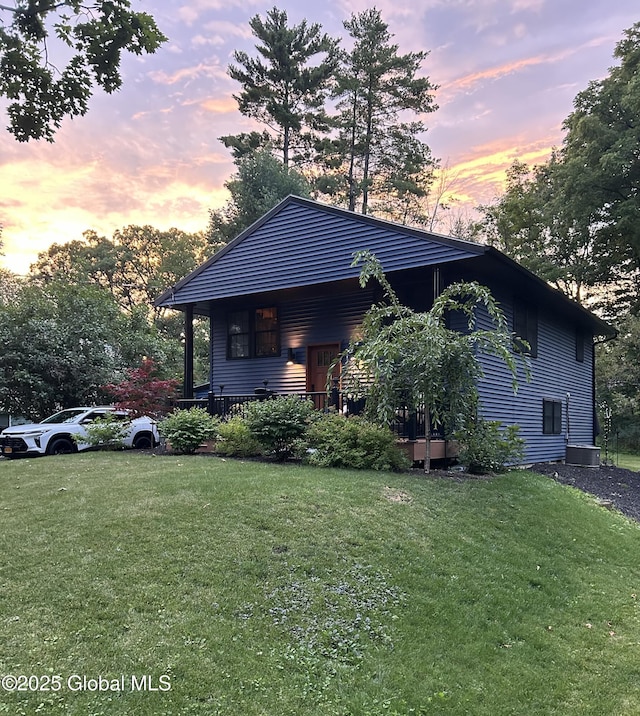 view of front of house with a yard and cooling unit