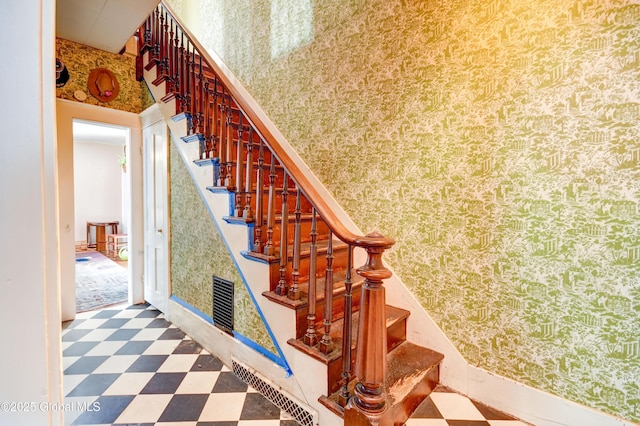 stairs featuring tile patterned floors, visible vents, and wallpapered walls