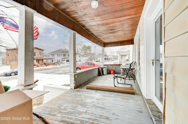 wooden terrace with a porch and a residential view