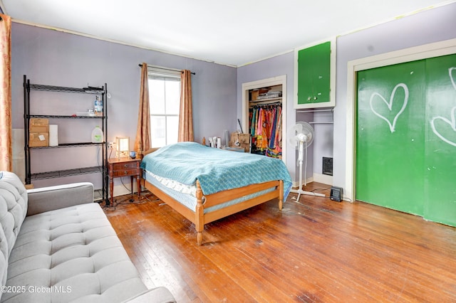 bedroom with visible vents and light wood-style floors